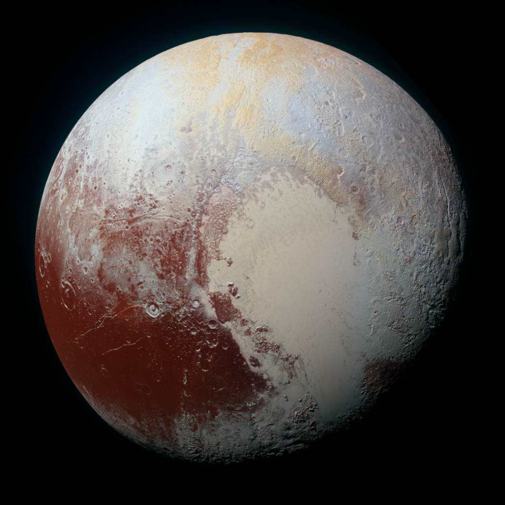 Image shows Pluto, with its pink heart-shaped region prominently displayed. The left side shows regions that are a brick-red color. The top shows mountainous features and is in shades of bluish-white and tan.