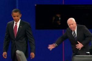 Screen capture of Obama-McCain debate with McCain's tongue out and him gesturing widely while off-balance.
