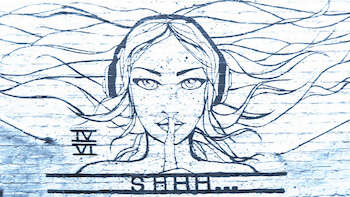 Photo of line-art graffitti in blue on a brick wall painted white. Image is a woman wearing headphones with her hair splayed out behind her and her finger to her lips. Text below reads, "Shhh..."