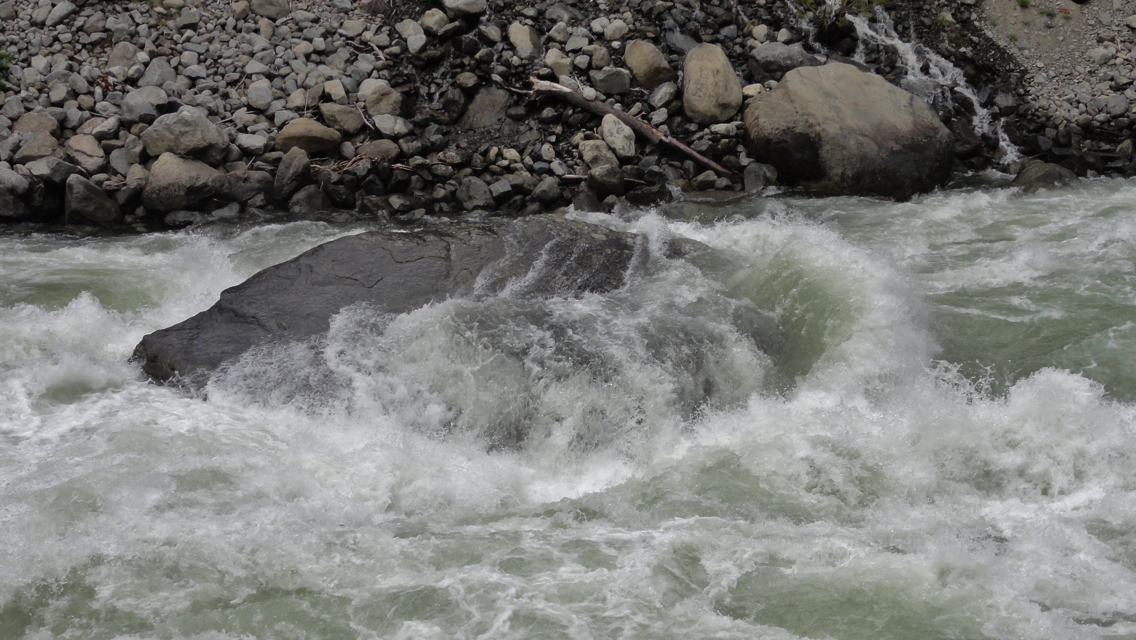 Wenatchee River wailing on a boulder.