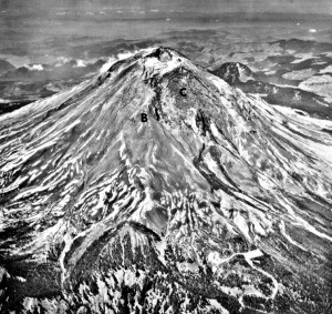Black and white aerial image shows Mount St. Helens looming over the surrounding landscape. The bulge is clearly visible. On it, the Forsyth Glacier, labeled with a C, is severely cracked. 