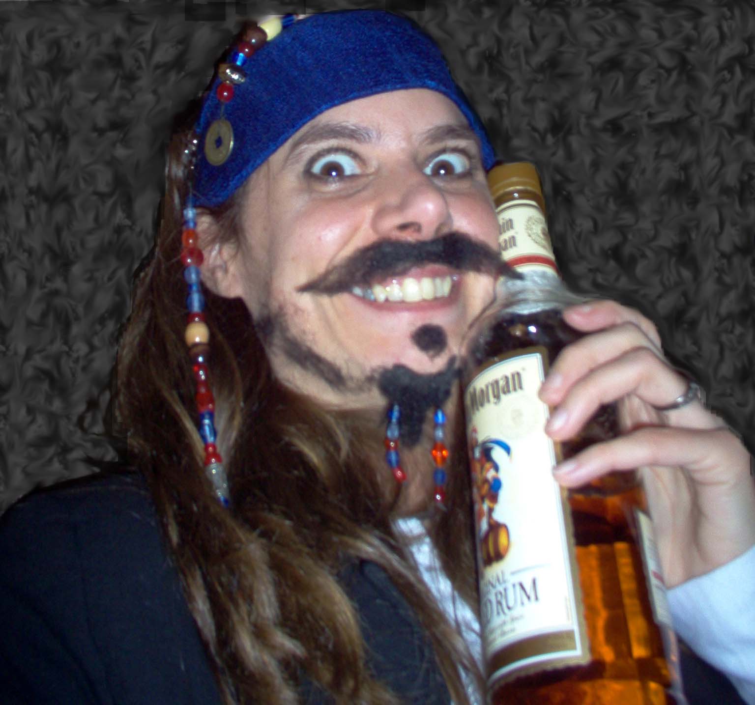 Image shows me dressed as Captain Jack Sparrow, holding a bottle of Captian Morgan rum.