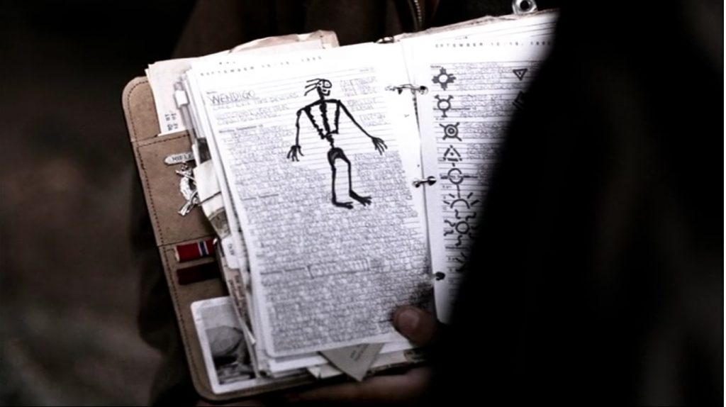 Image is a screenshot showing a page of John's journal. It has a petroglyphic drawing of a figure with a triangular chest and long, skinny arms and legs.