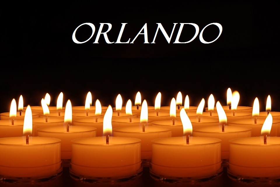 Image shows dozens of tealight candles burning against a black background. Above is the word Orlando.