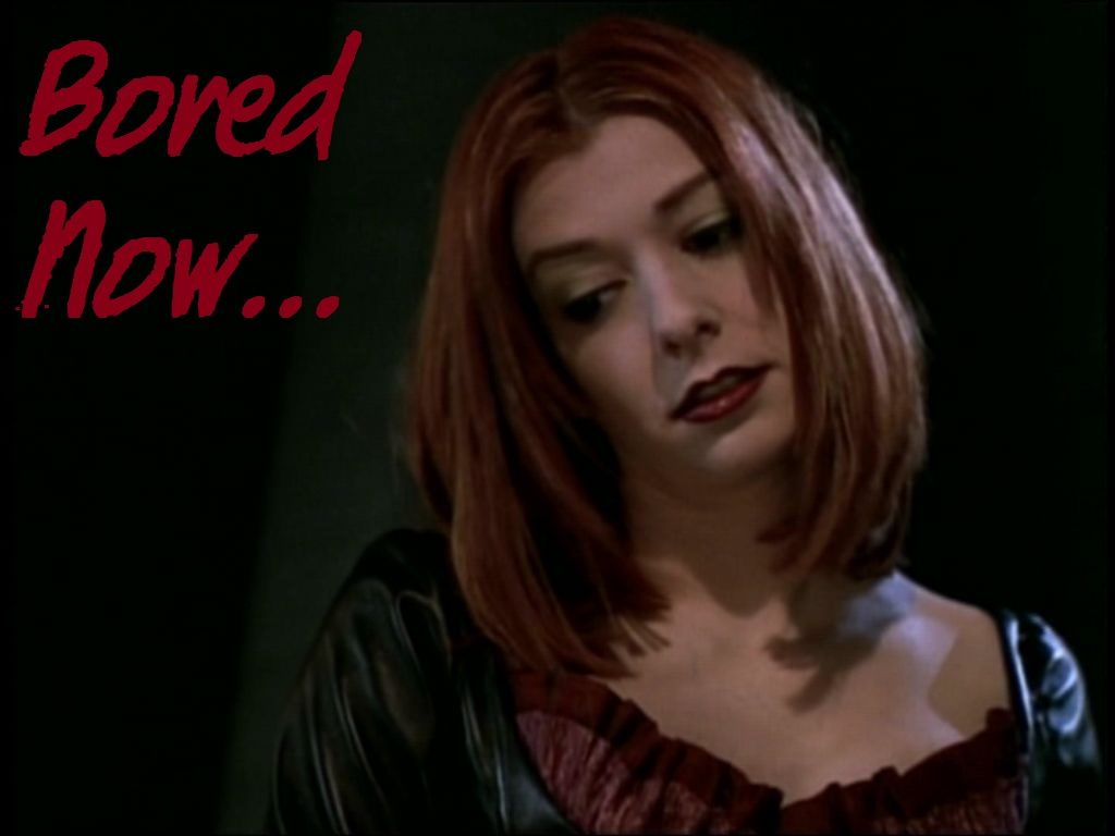 Image shows Evil! Willow from Buffy the Vampire Slayer, looking down at something off-camera with a bored and disappointed expression. Caption says, Bored now...