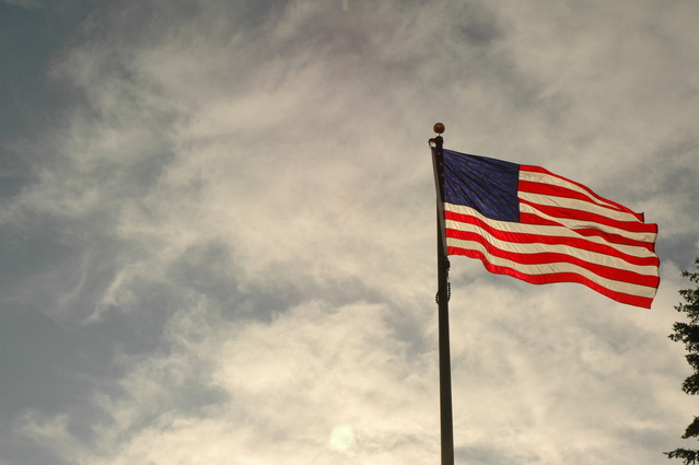 american flag flying on cloudy day