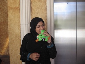 Heina in a headscarf at age 17 kissing a stuffed frog