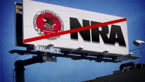 image of a billboard featuring the NRA logo and the letters NRA in bold black against a white backdrop with a red forward slash across the image