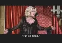 A white woman, Madeline Kahn from Blazing Saddles, stands in black lingerie, singing. The caption read "I'm so tired"