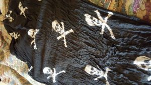 Black scarf with white skull and crossbones