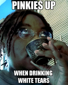 A black woman, the author, eyes slightly rolled, sips from a small tea cup. The caption says "Pinkies Up When Drinking White Tears"